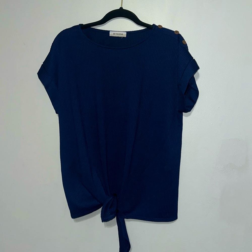 Top with buttons on shoulder, cuffed sleeve, and tie in front